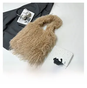 Close-up of camel faux fur tote bag with long fluffy texture and minimal handles