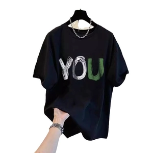 Oversize black cotton T-shirt with YOU artistic print and silver chain accessory