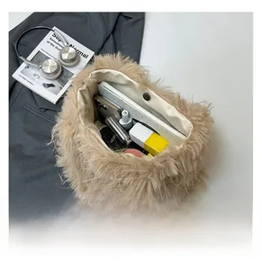 Detail view of large camel plush tote bag interior holding phone and cosmetics