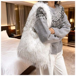 Close-up of white plush faux fur tote bag with long soft fringe and fluffy texture