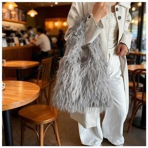 Close-up of fluffy grey faux fur tote bag with long plush texture and soft sheen