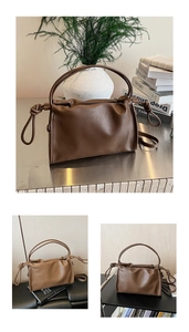 Detailed macro view of deep brown pleated leather bag with side knot and soft texture