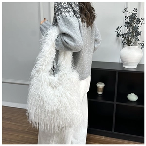 Side view of white faux fur tote bag with long plush texture worn by a model