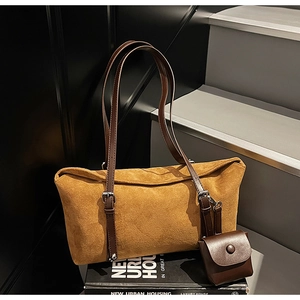 Close-up of suede tote bag with leather strap and detachable mini coin purse accessory