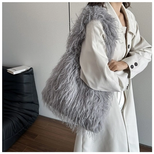 Detail of grey faux fur tote bag showing the soft fluffy texture and large shoulder strap