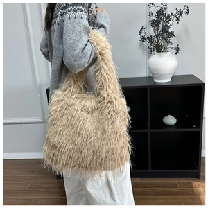 Side view of large plush faux fur tote bag in beige with a soft, fuzzy texture