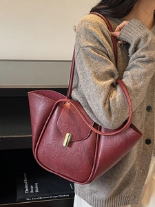 Elegant burgundy shell-shaped leather tote bag with unique pleated sides and gold buckle