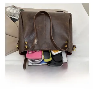 Detailed interior of vintage dark brown tote bag showing spacious storage capacity