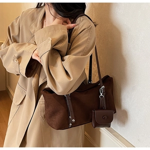 Detail of dark brown faux suede tote bag with rivets and mini coin purse attachment