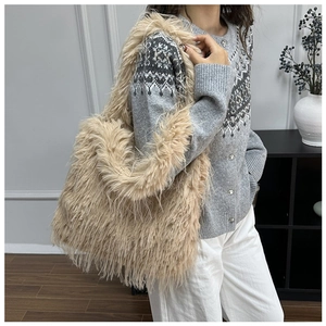 Plush faux fur tote bag in beige shown on model wearing a winter knit sweater
