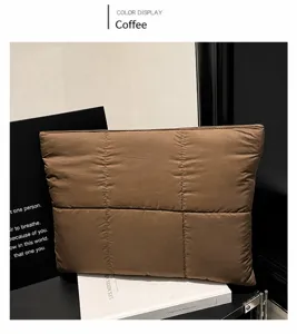Detailed view of the coffee brown quilted nylon fabric texture on a soft laptop sleeve