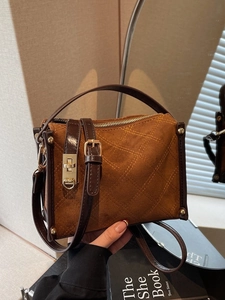 Brown vintage quilted suede handbag with gold hardware and versatile crossbody straps