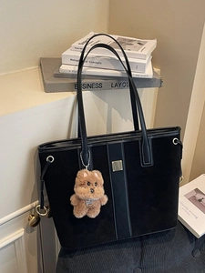 Large black suede tote bag with golden hardware and a cute brown plush bear charm