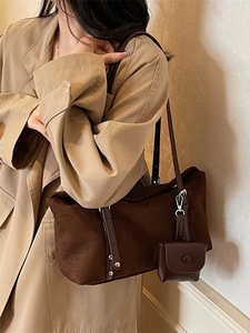 Retro brown frosted tote bag with metal rivets and small coin pouch shown on model