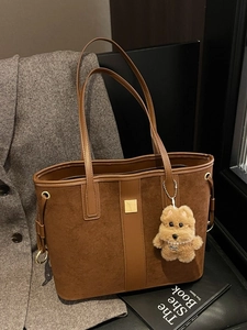 Brown leather tote bag with suede paneling and cute puppy charm for women