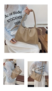 Detail of khaki pleated cloud bag with knotted handle and soft leather texture