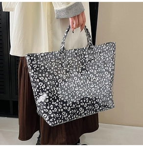 Macro detail of high-capacity leopard print tote bag with transparent waterproof texture