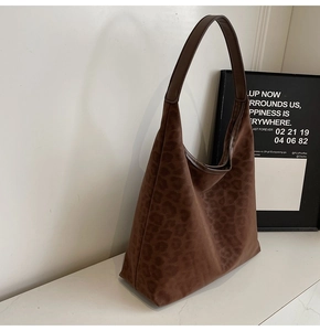 Detailed view of brown leopard print hobo tote bag in premium suede-textured material