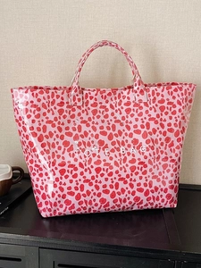 Large red leopard print tote bag in glossy finish with white TOTE BAG lettering