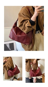 Detail of burgundy leather shoulder bag with smooth texture and vintage commute style
