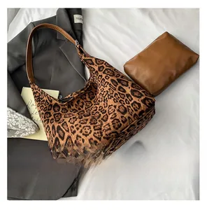 Detail view of large leopard print hobo bag with matching brown zipper pouch accessory