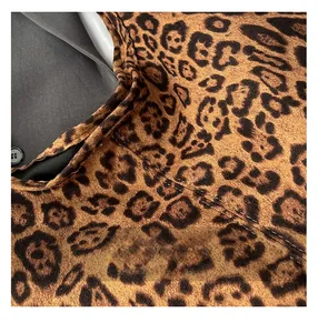 Macro shot showing refined stitching and black button on leopard print tote bag fabric