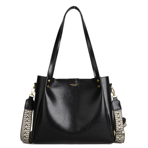 Retro black leather tote bag with gold logo and patterned ethnic shoulder strap
