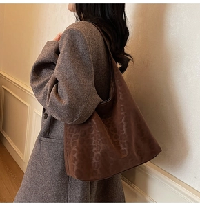 Brown leopard print hobo tote bag styled with a professional autumn outfit in an office