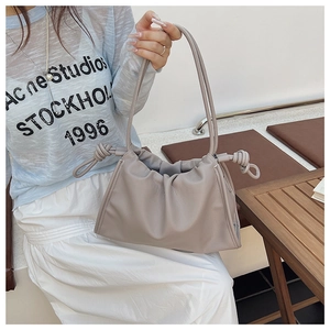 Detail view of the soft pleated texture and leather grain of the stylish cloud bag