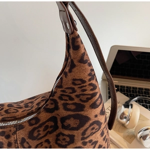 Close-up of leopard print shoulder bag with silver zipper and leather strap detail