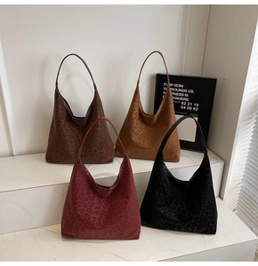 Detail of large leopard print tote bags in four colors on a white minimalist stage