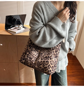 Lifestyle shot of large leopard print tote bag with laptop in a cozy home setting