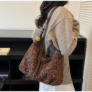Detailed leopard print tote bag with brown faux leather strap and plush charm