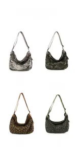 Detail view of large canvas hobo bags in camouflage and leopard print patterns with straps