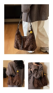 Detailed view of leopard print tote bag with yellow pom-pom and silver hardware