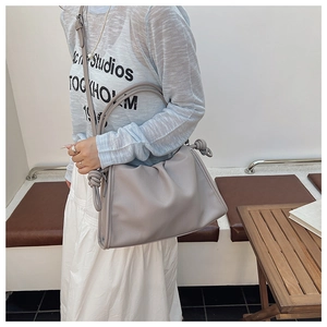 Detail view of the soft pleated leather bag with a unique knot shoulder strap design