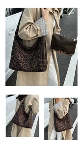 Detailed view of leopard print tote bag with a brown zipper pouch in an outdoor setting