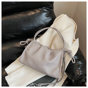 Detail showing soft lavender ruched cloud bag leather texture and oversized decorative knots