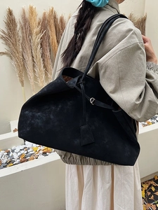 Classic black suede tote bag with large capacity for women shown in autumn outdoor scene