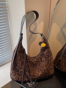 Vintage leopard print hobo bag with fringe detail and fuzzy charm for women
