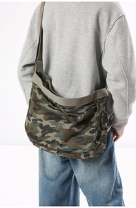 Detailed view of high-density camo canvas bag with wide strap and side button pocket