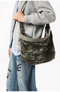 Close-up of camo canvas crossbody bag showing durable texture and adjustable strap