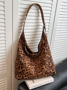 Large leopard print tote bag with adjustable brown leather straps and hobo silhouette