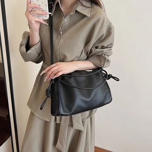 French pleated black cloud bag with soft leather texture and knotted shoulder strap
