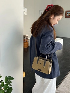 Retro khaki tote bag with dark brown leather trim for women shown in lifestyle setting