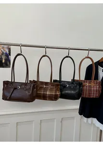 Detail showing vintage plaid and solid faux leather tote bags in four rich color options