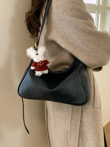 Retro black faux leather hobo bag with white stitching and cute plush bear charm