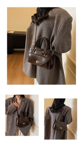 Detail view of dark brown retro crossbody bag with golden rotary buckle and glossy finish
