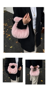 Close-up of pink faux fur plush handbag showing soft texture and fuzzy round design