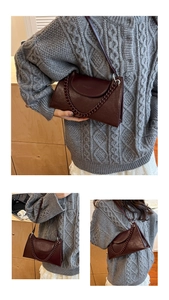 Detail of burgundy chain baguette bag showing wine red texture and shoulder strap style